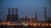 FILE - A refinery is lit up at the Jubail Industrial City, about 95 kilometers north of Dammam, in Saudi Arabia's eastern province overlooking the Gulf, Dec. 11, 2019.
