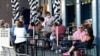 FILE - Customers sit outside a cafe at Bondi Beach in Sydney, Australia, Jan. 8, 2022. 