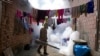 FILE - A health worker fumigates to help mitigate the spread of dengue at a home in Caranavi, Bolivia, March 2, 2023. 