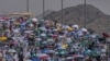 FILE - Muslim pilgrims use umbrellas to shield themselves from the sun as they arrive to cast stones at pillars in the symbolic stoning of the devil, the last rite of the annual hajj, in Mina, near the holy city of Mecca, Saudi Arabia, June 18, 2024.