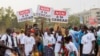 Supporter of the Alliance Of Sahel States hold placards reading 'No to ECOWAS' during a rally to celebrate Mali, Burkina Faso and Niger leaving the Economic Community of West African States in Bamako, Mali, on Feb. 1, 2024. 