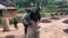 FILE - Workers fill a sack with cocoa beans in Ntui village, Cameroon, Dec. 16, 2017. Some cocoa farmers have blocked the crop from leaving their farms in protest over a ban on exports to Nigeria that was announced in June 2023. 