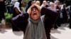FILE — A woman mourns at the funeral of four Palestinians killed in clashes with Israeli settlers, near Nablus in the Israeli-occupied West Bank, Oct. 12, 2023.