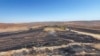 This handout photograph taken and released on June 21, 2024, by Turkish news agency DHA (Demiroren News Agency) shows a burnt field after a wildfire swept overnight through two areas between the cities of Diyarbakir and Mardin in southeastern Turkey.