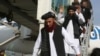 Abdul Karim (L) and Abdul Zahir (C), two former prisoners who had been held at the U.S. detention center in Guantanamo Bay before being transferred to Oman, are seen as they arrive at Kabul airport in Kabul, Afghanistan, Feb. 12, 2024. 