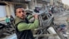 A man gestures in front of the car in which three sons of Hamas leader Ismail Haniyeh were reportedly killed in an Israeli airstrike in al-Shati camp, west of Gaza City on April 10, 2024.