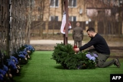 President Volodymyr Zelenskyy honoring the memory of the victims of the Russian occupation at a memorial in the town of Bucha, March 31, 2024. (Ukrainian Presidential Press Service/AFP)