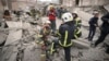 First response officers inspect the damage after a Russian air attack in Kyiv, Ukraine, March 25, 2024.