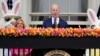 President Joe Biden speaks as first lady Jill Biden looks on at the White House Easter Egg Roll on the South Lawn of the White House, in Washington, April 1, 2024.