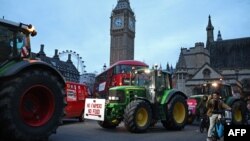 Farmers drive tractors around Parliament Square during a demonstration organized by Save British Farming against UK food policy, substandard imports and food labeling regulations, in London, March 25, 2024.