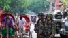 Bangladesh army stand guard near the country's Secretariat as the curfew is relaxed after the anti-quota protests, in Dhaka on July 27, 2024.