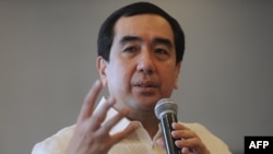 FILE - Andres Bautista, chairman of the Philippines' vote watchdog Commission on Elections, gestures as he speaks to journalists in Manila on Aug. 7, 2015. 