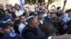 FILE - Israel's National Security Minister Itamar Ben-Gvir, center, attends a march marking Jerusalem Day, in front of the Damascus Gate of Jerusalem's Old City, May 18, 2023. 