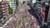 In this aerial photograph Bangladesh Nationalist Party (BNP) activists gather near a poster of BNP chairperson Khaleda Zia, during a rally in Dhaka on Aug. 7, 2024.