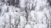 FILE - A soldier from the Jaeger Battalion GSV of the Norwegian Armed Forces that monitors the 196-kilometer-long border between Norway and Russia, is barely seen in the snow during the NATO Nordic Response 24 military exercise, March 9, 2024.