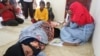 Rohingya Muslim refugees rest at the Samatiga District Office after Indonesian fishermen rescued dozens after high tides capsized their boat in waters off the West Aceh, in Aceh province, Indonesia, March 20, 2024, in this photo taken by Antara Foto.