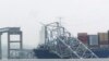 A container ship rests against the wreckage of the Francis Scott Key Bridge on March 28, 2024, in Baltimore, Maryland. Officials are turning their attention to what promises to be a massive salvage operation. 