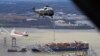 President Joe Biden, aboard Marine One, takes an aerial tour of the collapsed Francis Scott Key Bridge in Baltimore, Maryland, April 5, 2024.