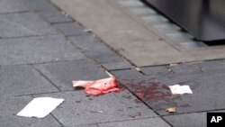 Blood is seen on the pavement in Leicester Square, in London, Aug. 12, 2024. 
