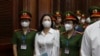FILE - Vietnamese real estate tycoon Truong My Lan, front center, is escorted into a courtroom in Ho Chi Minh City, Vietnam, March 5, 2024.