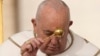 Pope Francis asperses holy water as he celebrates Easter Mass in St. Peter's Square at the Vatican, March 31, 2024. 