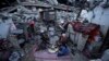 Members of the Al-Rabaya family break their fast during the Muslim holy month of Ramadan outside their home, destroyed by Israeli airstrikes, in Rafah, Gaza Strip, March 18, 2024.
