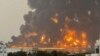 A handout picture obtained from Yemen's Huthi Ansarullah Media Center shows a huge column of fire erupting following strikes in the Yemeni rebel-held port city of Hodeidah on July 20, 2024. 