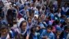 Students leave after attending school as authorities announced reduced classroom hours due to soaring temperatures, in Lahore, Pakistan, May 21, 2024.