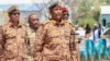 FILE - Sudan's army chief Abdel Fattah al-Burhan visits casualties receiving treatment at a hospital in the southeastern Gedaref state, April 10, 2024. De facto leader received an Iranian ambassador, July 21, 2024 and sent his own to Tehran, the government said.