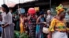 FILE - Women shop at a street market in Banjul, Gambia, Dec. 3, 2021. The country may soon reverse its ban on female genital mutilation, a practice that has been on the rise worldwide in recent years despite moves to outlaw it.