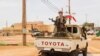 FILE - A fighter for Coordination of Azawad Movements patrols through town during the Congress for the Fusion of Movements in Kidal, Aug. 28, 2022.