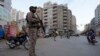 FILE - Paramilitary soldiers stand guard along road side to ensure security in Karachi, Pakistan, April 9, 2024.
