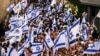 Israelis sing and dance with flags by Damascus gate to Jerusalem's Old City as they mark Jerusalem Day, in Jerusalem, May 18, 2023.