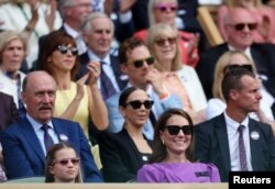 Britain's Catherine, Princess of Wales and Princess Charlotte are seen in the royal box during the men's singles final between Spain's Carlos Alcaraz and Serbia's Novak Djokovic, Wimbledon, July 14, 2024.
