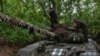 Ukrainian servicemen of the 65th brigade prepare their tank for the next operation to defend their positions at the frontline in Zaporizhzhia region, Ukraine, April 18, 2024. 
