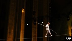 Philippe Petit performs during his show Towering, at the Cathedral Church of St. John the Divine, in New York City on Aug. 8, 2024. 
