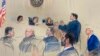 This artist sketch depicts former President Donald Trump, seated right, listening as his attorney D. John Sauer, standing, speaks before the D.C. Circuit Court of Appeals at the federal courthouse, Jan. 9, 2024 in Washington.