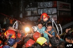 Rescuers extract victims from a building in Dhaka, Bangladesh, that caught fire, Feb. 29, 2024. Fire officials told reporters they suspected the inferno was caused by a gas cylinder explosion.