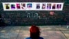 FILE - A person visits a makeshift memorial near the scene of a shooting targeting Black people at a supermarket, in Buffalo, on May 19, 2022.
