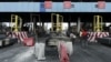 FILE - Workers clean up the Lekki toll gate, the site where soldiers had opened fire on protesters rallying against alleged police brutality, in Lagos, Nigeria, Oct. 24, 2020. 
