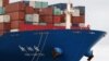 A worker is seen on the bow of a container ship docked inside Botany Bay in Sydney, Australia, Oct. 28, 2020. 