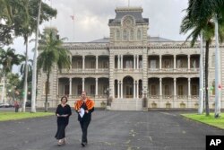 Paula Akana, left, executive director of Iolani Palace, and Hailama Farden, of Hale O Na Aliʻi O Hawaii, a royal Hawaiian society, arrive at a news conference, Dec. 12, 2022, at the palace in Honolulu to announce the death of Abigail Kinoiki Kekaulike Kawānanakoa.