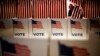 FILE - A voter in New Hampshire steps out of a voting booth after marking his ballot at a polling site for the New Hampshire primary, Feb. 9, 2016, in Nashua, New Hampshire.