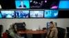 FILE - Afghan journalists Banafsha Binesh, right, speaks with her colleague Wheeda Hassan, at TOLO TV newsroom in Kabul, Afghanistan, Feb. 8, 2022.