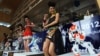 FILE - Humanoid robots called Nao, developed by a French company, Aldebaran Robotics, dance along with models to mark the opening of a press conference of the Manufacturing Expo in Bangkok, June 19, 2012.