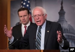 FILE - Sen. Bernie Sanders, I-Vt., joined by Sen. Chris Murphy, D-Conn., holds a news conference after the Senate passed a resolution he introduced that would pull assistance from the Saudi-led war in Yemen, Dec. 13, 2018.