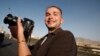 FILE - Luke Somers, 33, an American photojournalist who was kidnapped over a year ago by al-Qaida, poses for a picture during a parade marking the second anniversary of the revolution in Sanaa, Yemen.