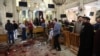 A general view shows people looking at the aftermath following a bomb blast which struck worshipers gathering to celebrate Palm Sunday at a Coptic Church in the Nile Delta City of Tanta, 120 kilometers (75 miles) north of Cairo, April 9, 2017.