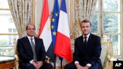 FILE - French President Emmanuel Macron, right, meets Egyptian President Abdel-Fattah el-Sissi at the Elysee Palace in Paris, France, Oct. 24, 2017.