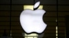 FILE - The Apple logo is illuminated at a store in Munich, Germany, Dec. 16, 2020.